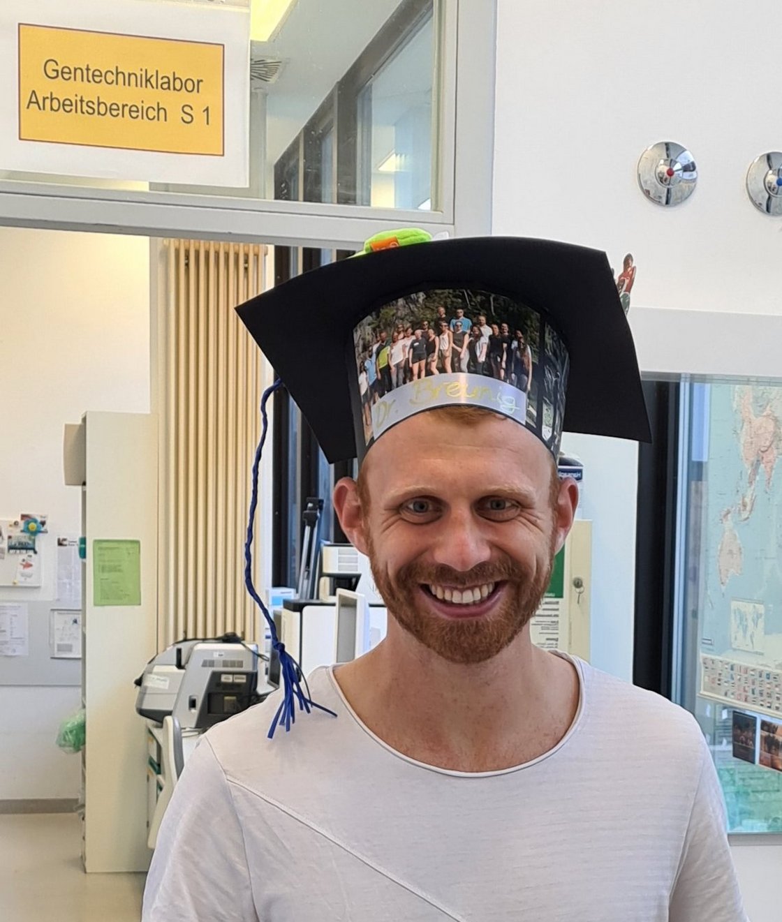 Shows Markus Breunig with his PhD hat after his defense