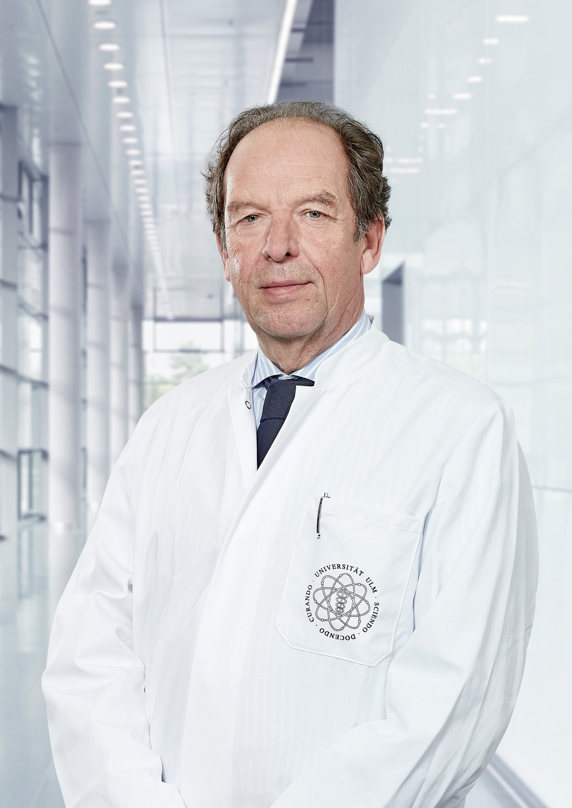 Photo of Prof. Klaus-Michael Debatin standing in a corridor of the hospital